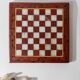 Vintage marble chess set from the 1960s, cream, burgundy and gold board with metal inlay, stone pieces.