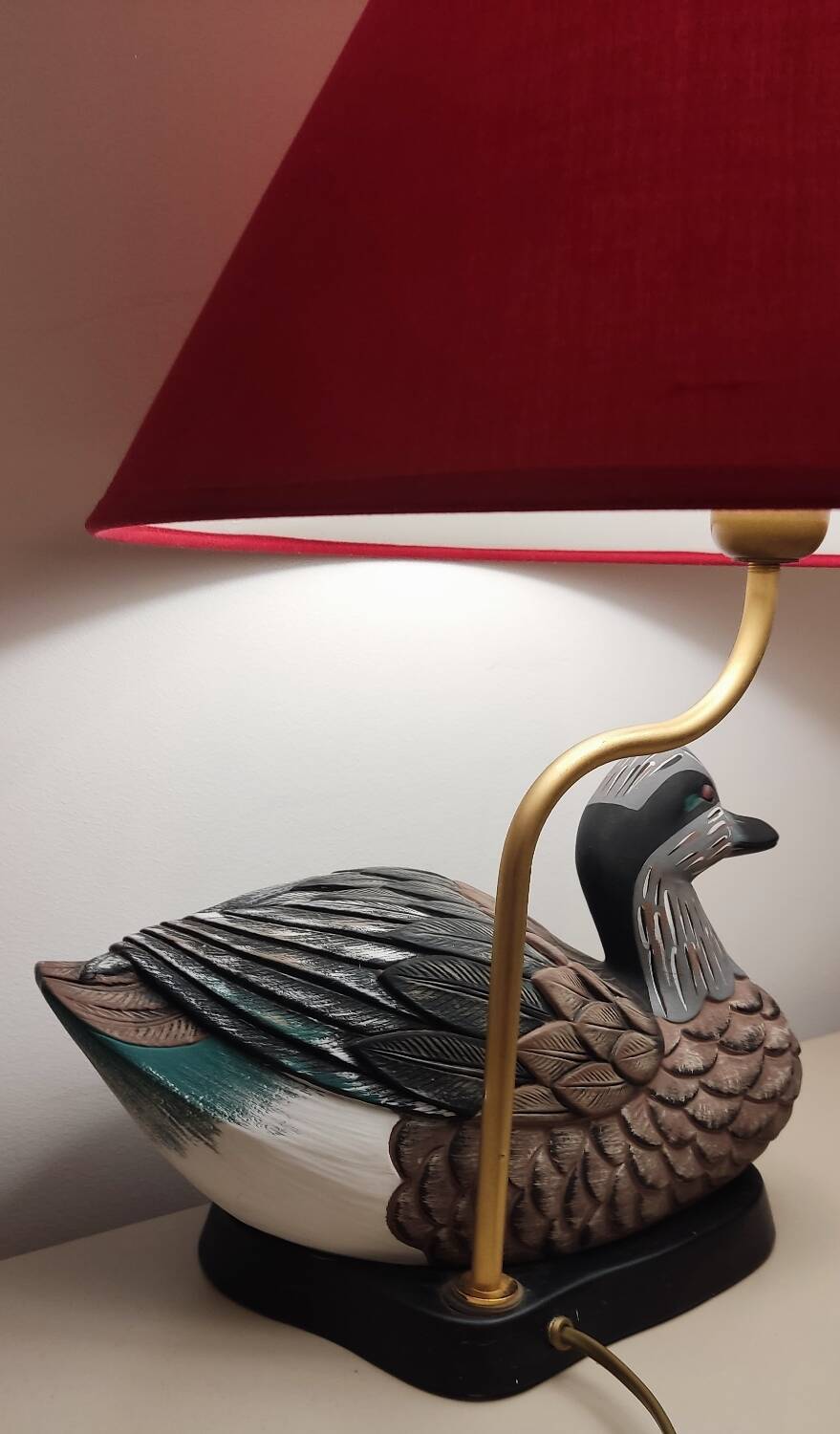 Decorative table lamp with a sculpted duck-shaped base and painted finish.