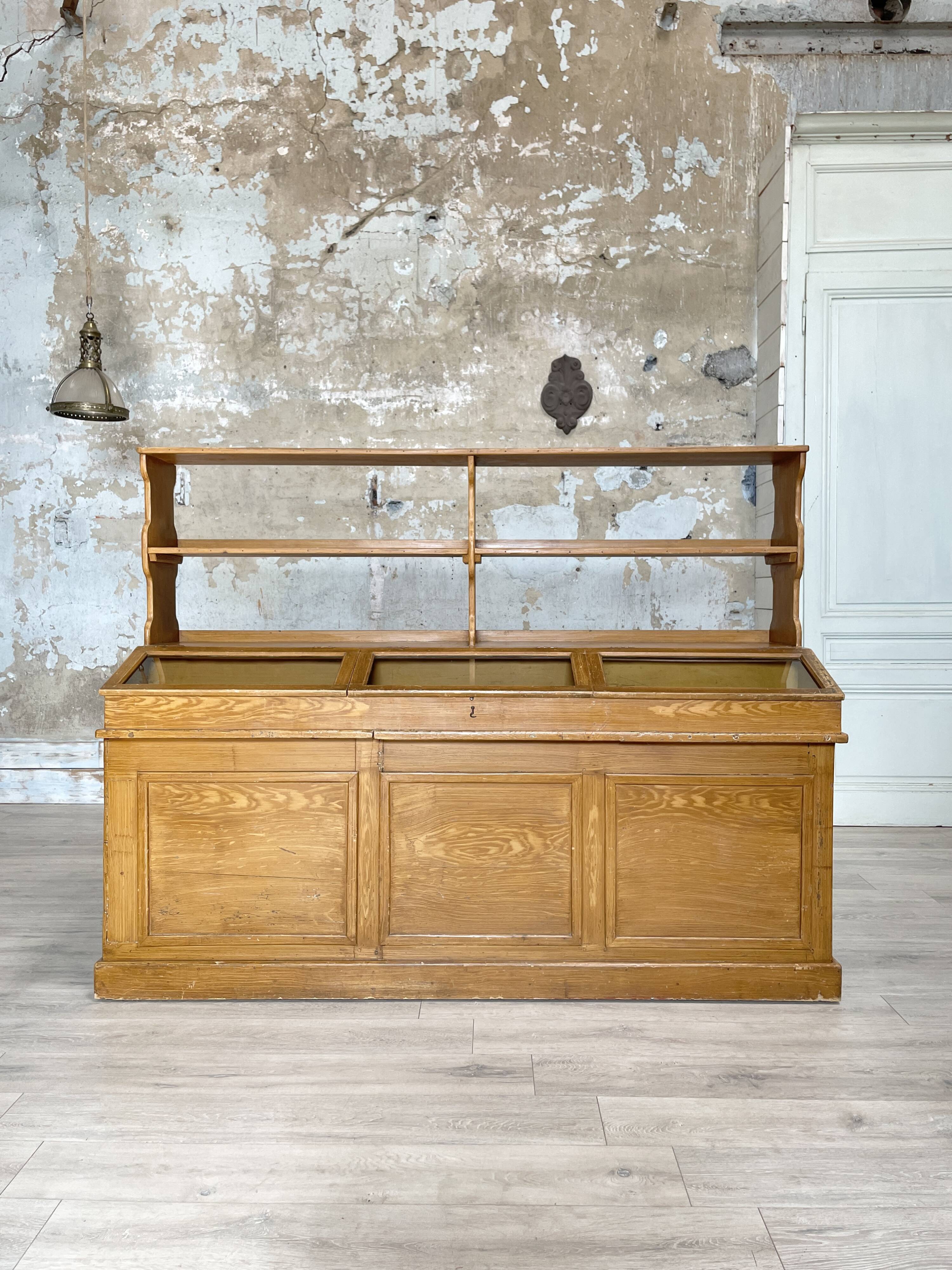 Wooden hardware cabinet painted with wood effect, circa 1940.
