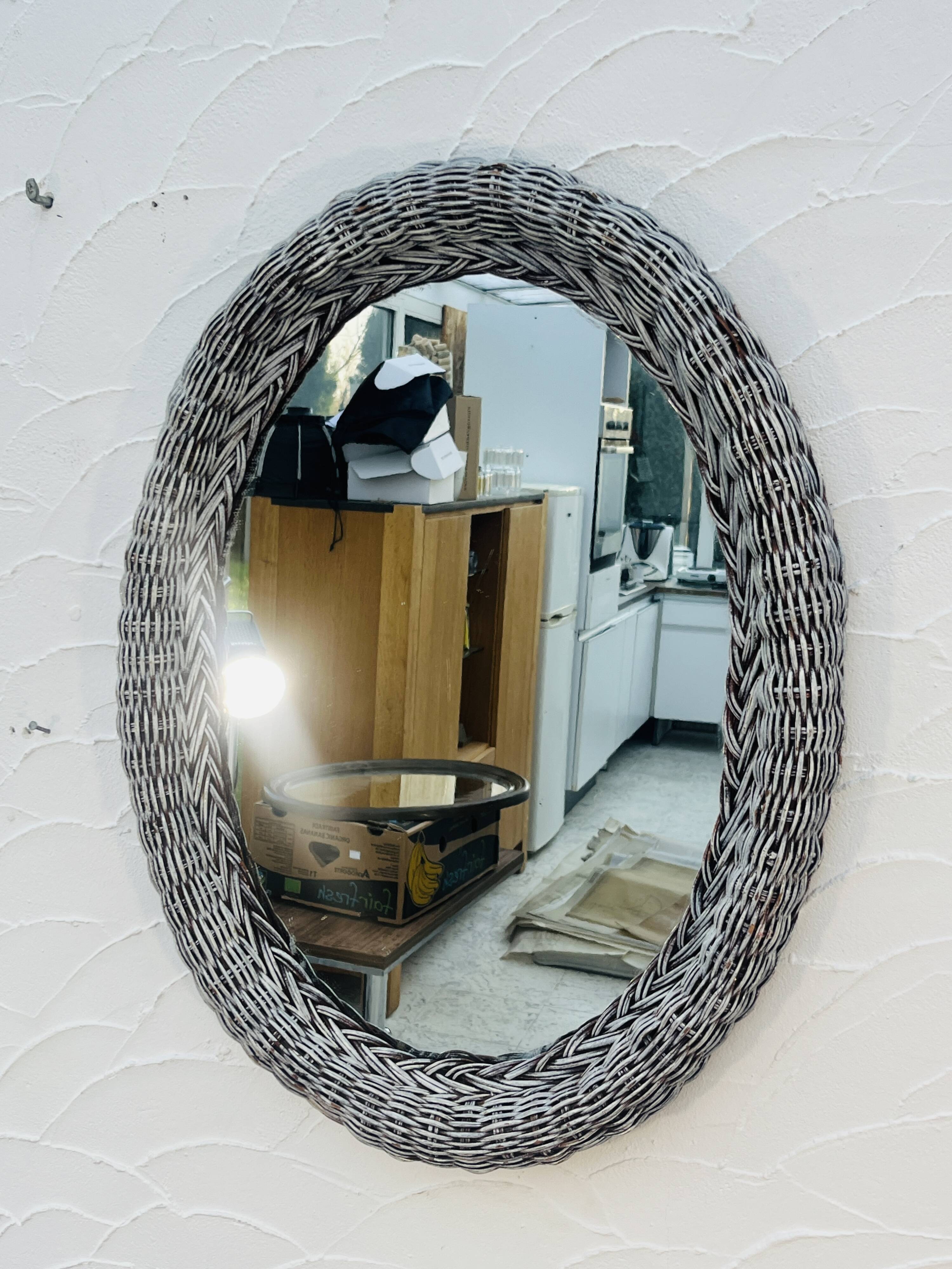 Vintage oval wicker mirror from the 1960s.