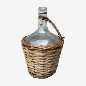 Bottle in clear glass with wicker