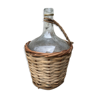 Bottle in clear glass with wicker