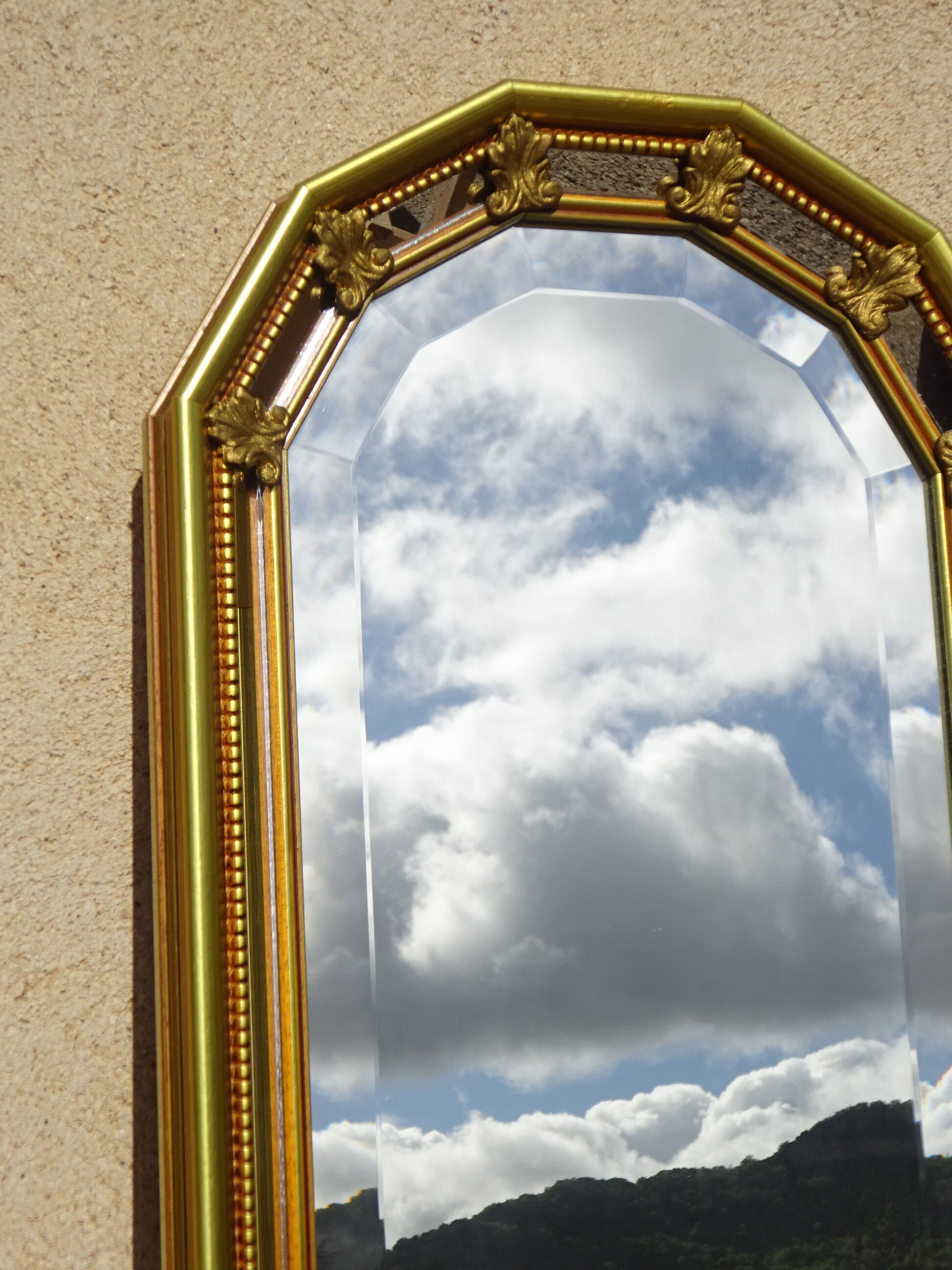 Vertical mirror, gold frame with beading.
