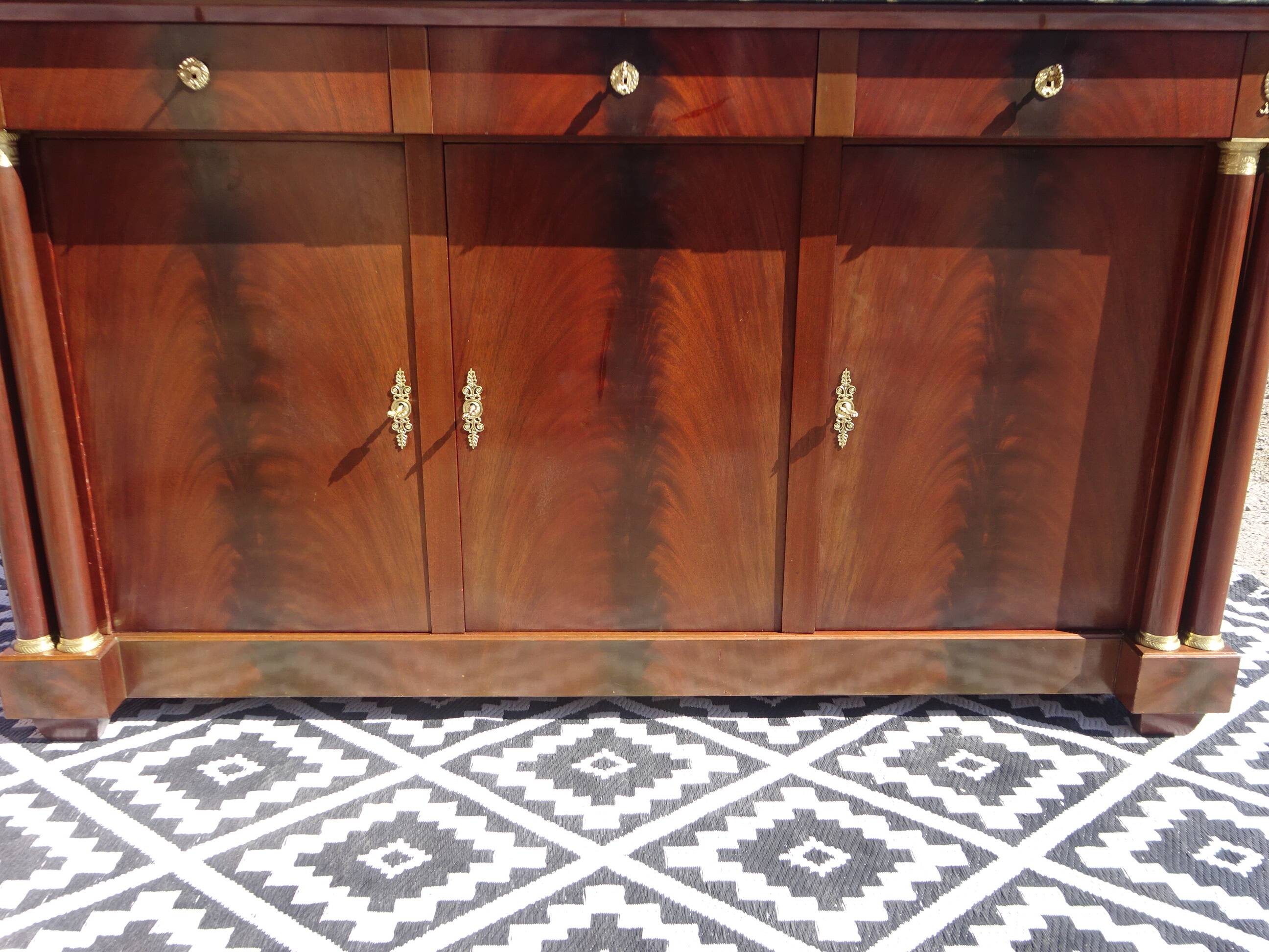 Flamed mahogany enfilade with sea green marble in Empire style.