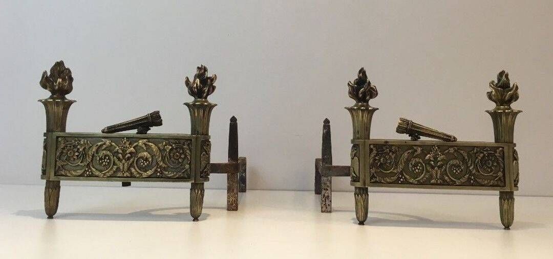 Pair of Empire Period Chenets in Chiselled Bronze with Torches and Leaf Frieze