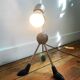 Articulated tripod foot lamp inspired by the Memphis movement