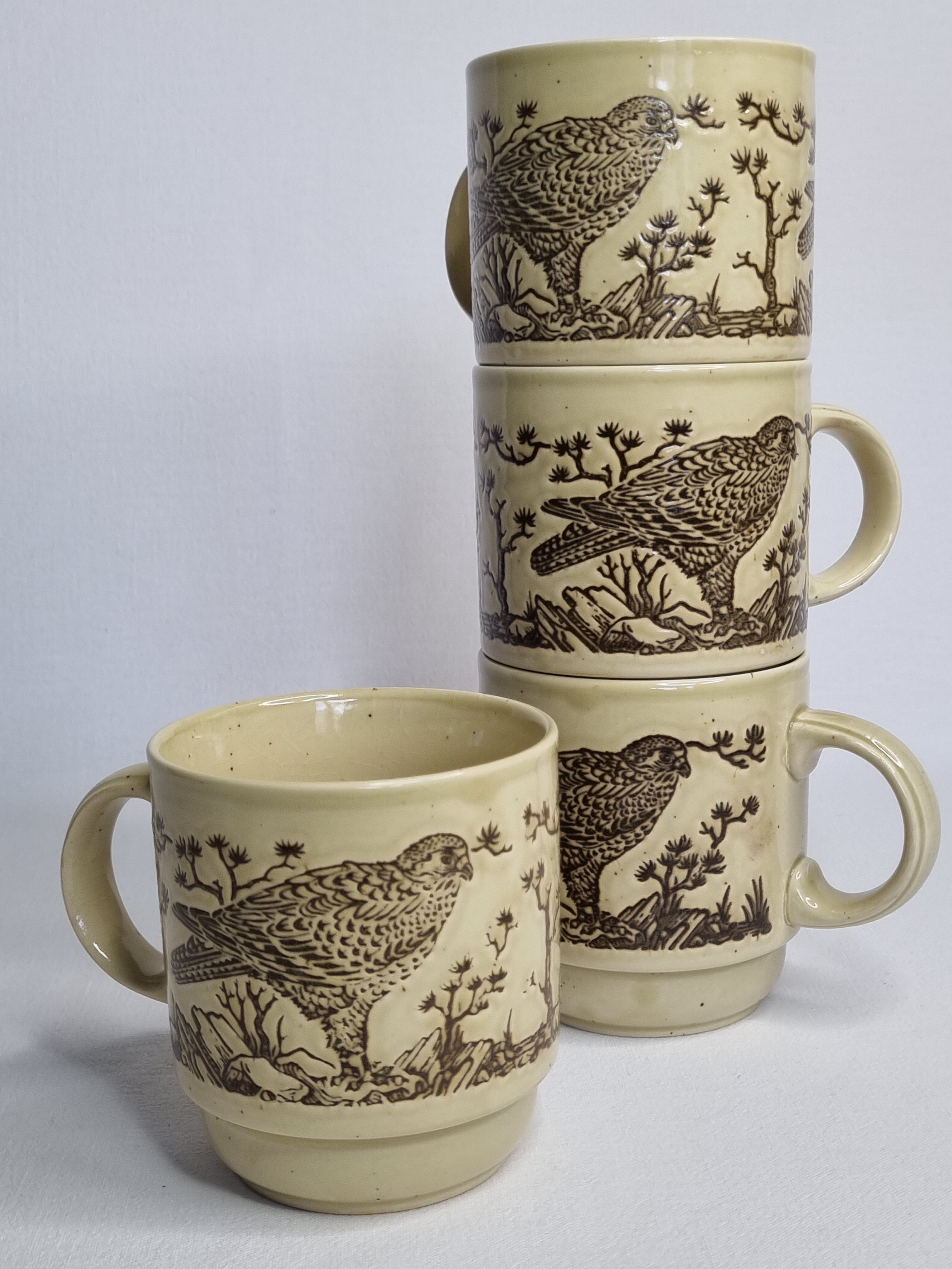 Set of four mugs in enamelled sandstone with bird decoration, made in england