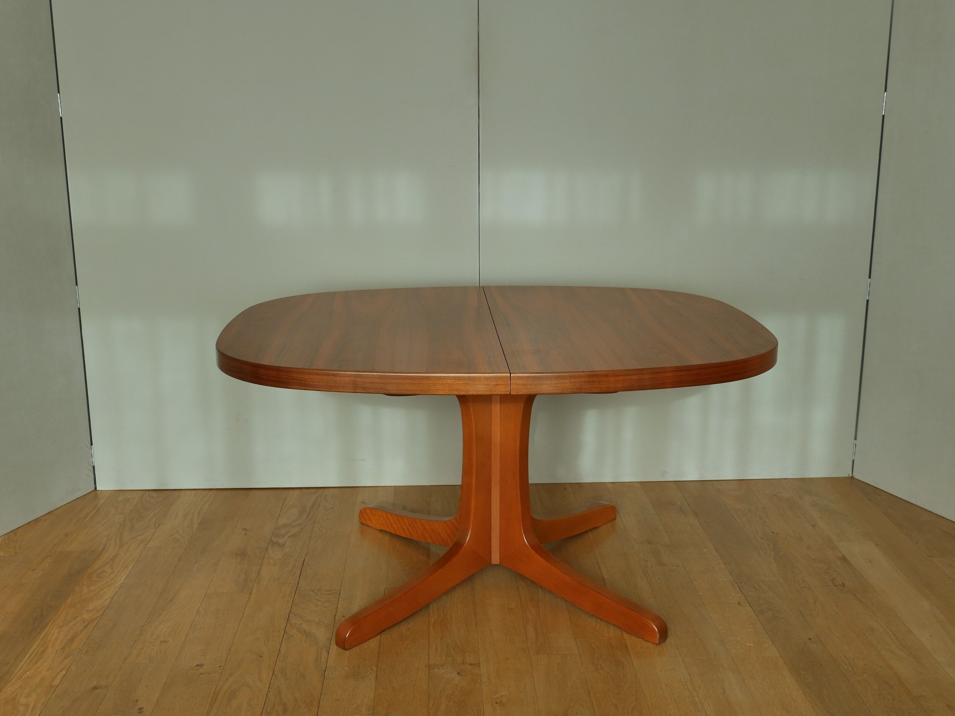 Oval walnut table with extension cords