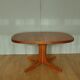 Oval walnut table with extension cords