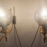 Pair of vintage gold wall sconces with transparent globes