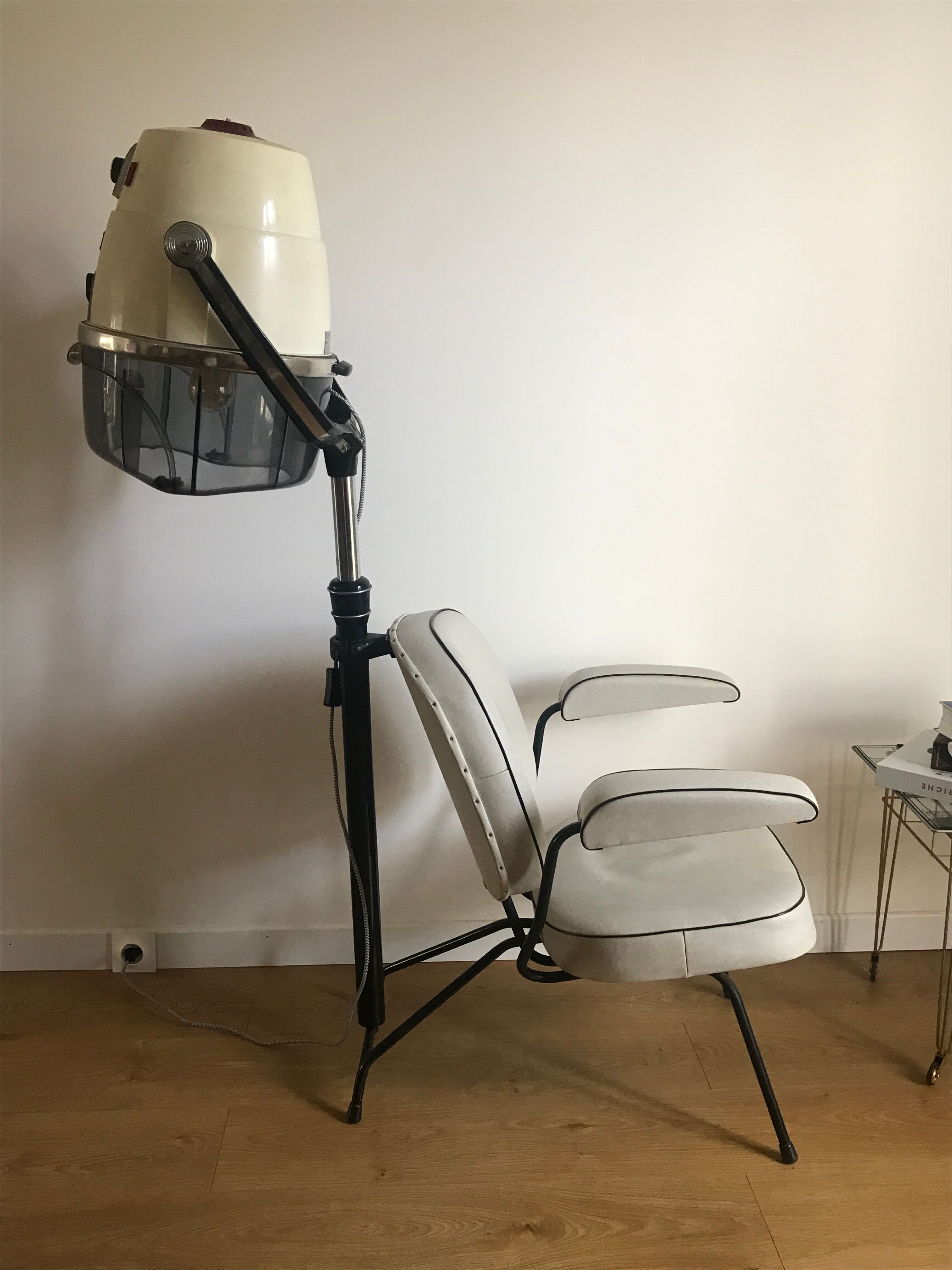 Vintage hairdresser's armchair with helmet transformed into a lamp