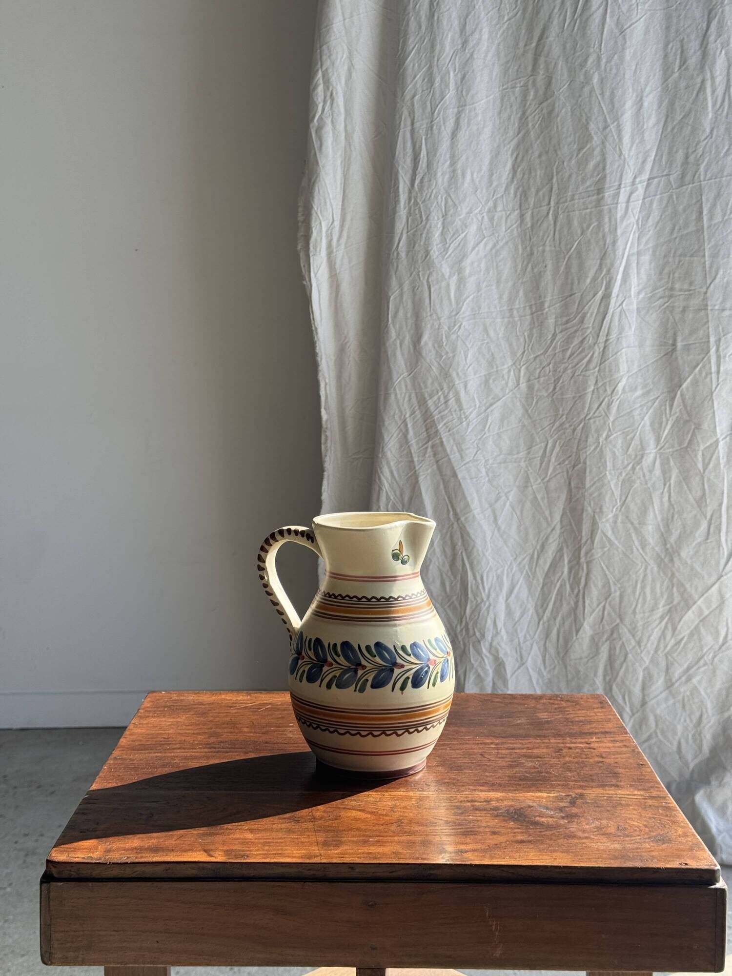Beige carafe with stylized blue flower friezes