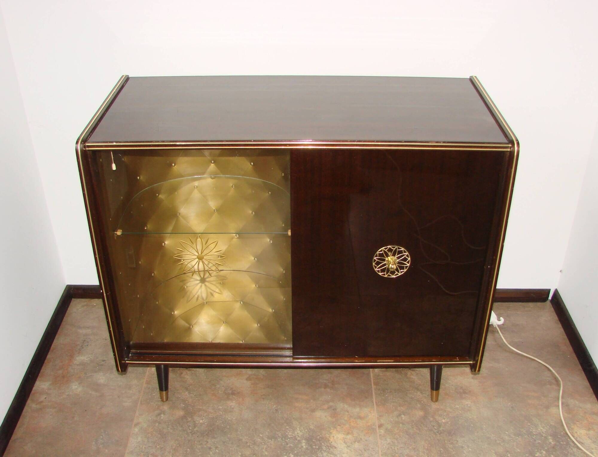 A vintage cabinet with a record player and a bar, 1960s.