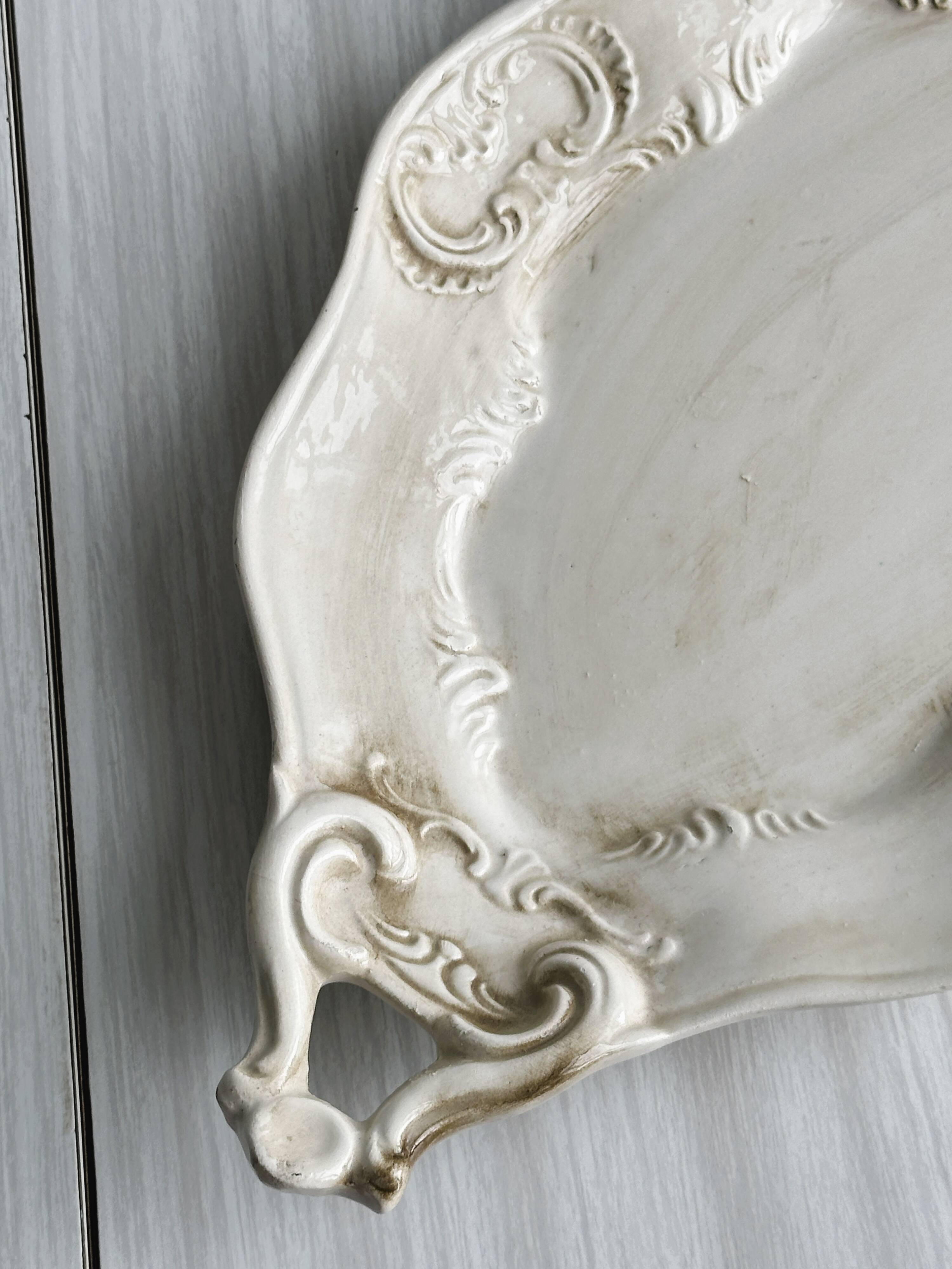 Tray, old dish with handles and relief patterns.