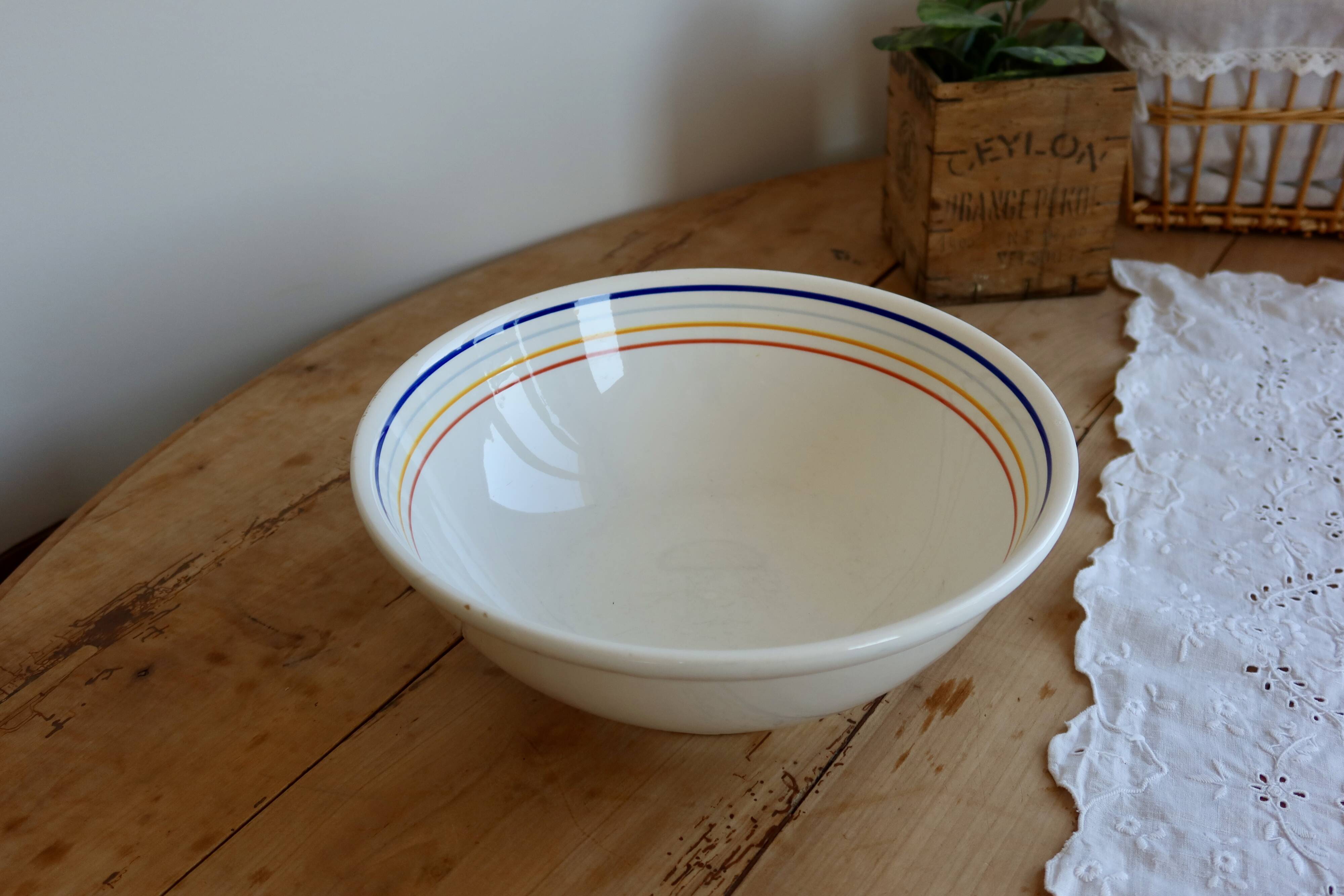 Vintage porcelain salad bowl with multicoloured borders.