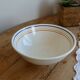 Vintage porcelain salad bowl with multicoloured borders.