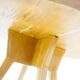 Round dining table in Wood Wood with brass details.