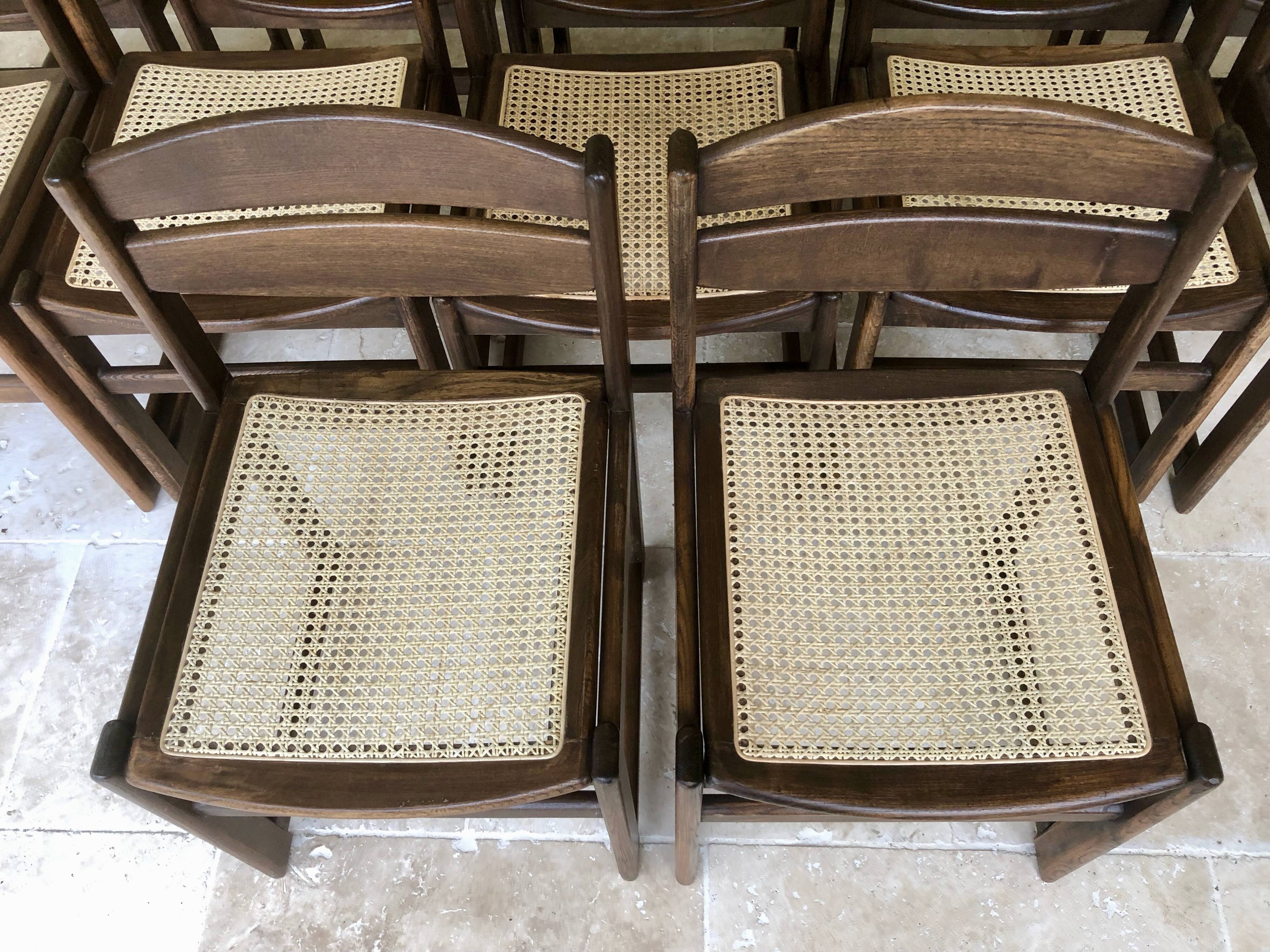 Set of 12 "sledge" dining chairs in walnut and cane.