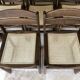 Set of 12 "sledge" dining chairs in walnut and cane.