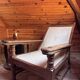 Vintage armchair in solid wood and geometric weaving – lodge spirit