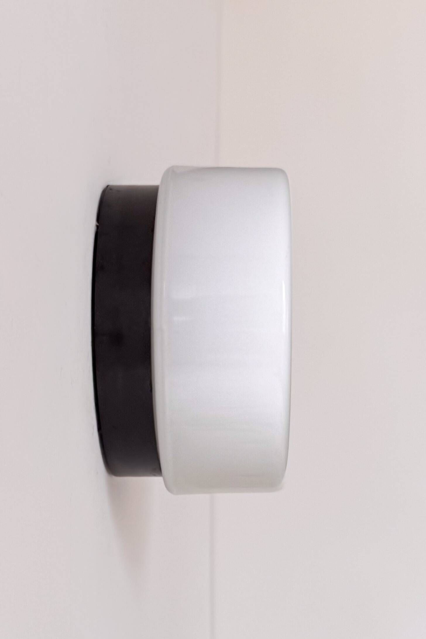 Vintage wall light in black Bakelite and opaline, France 1970.