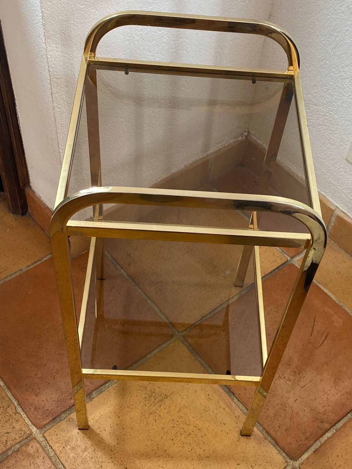 Gold metal and smoked glass console table.