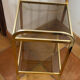 Gold metal and smoked glass console table.
