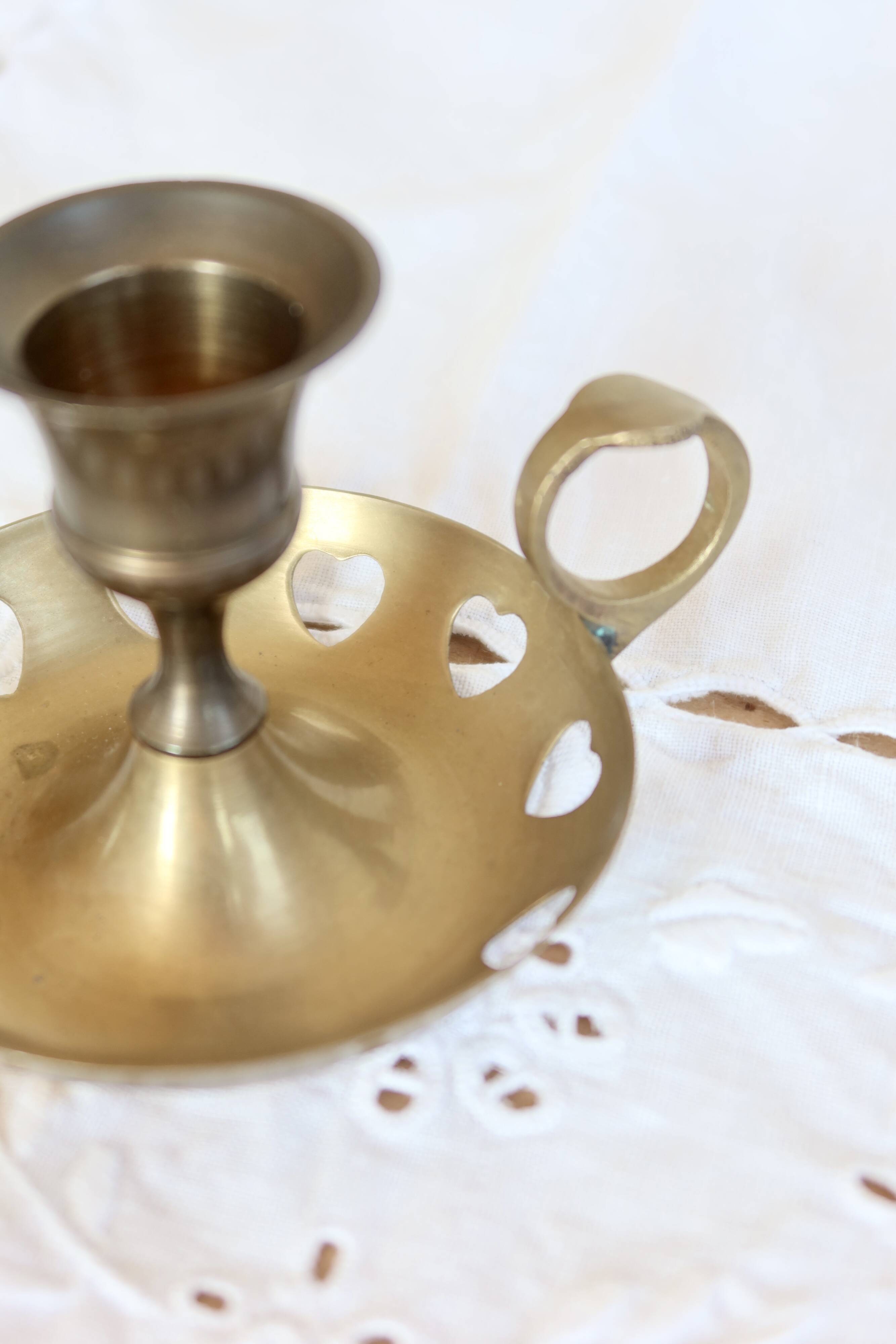 Antique brass rat trap with heart patterns.