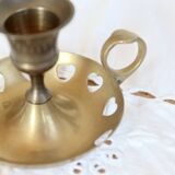 Antique brass rat trap with heart patterns.