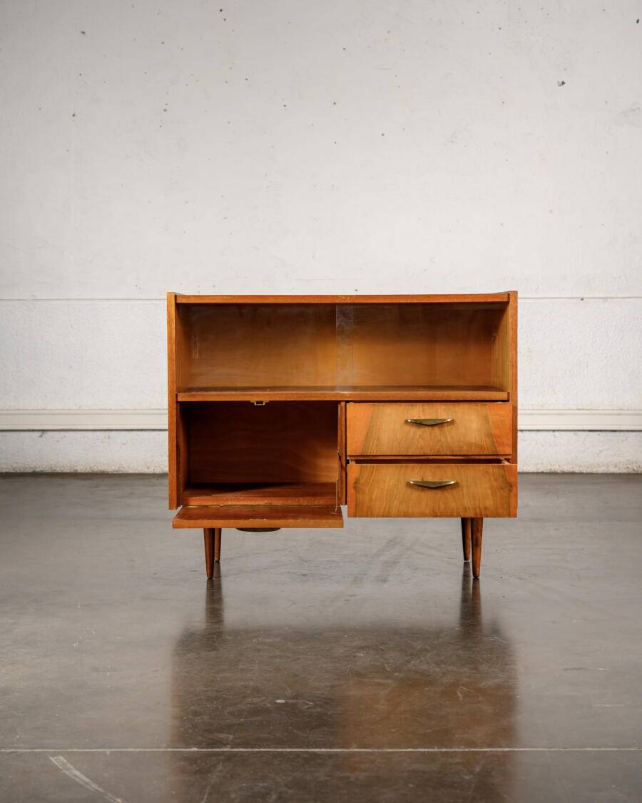 Old TV cabinet with brass handles.