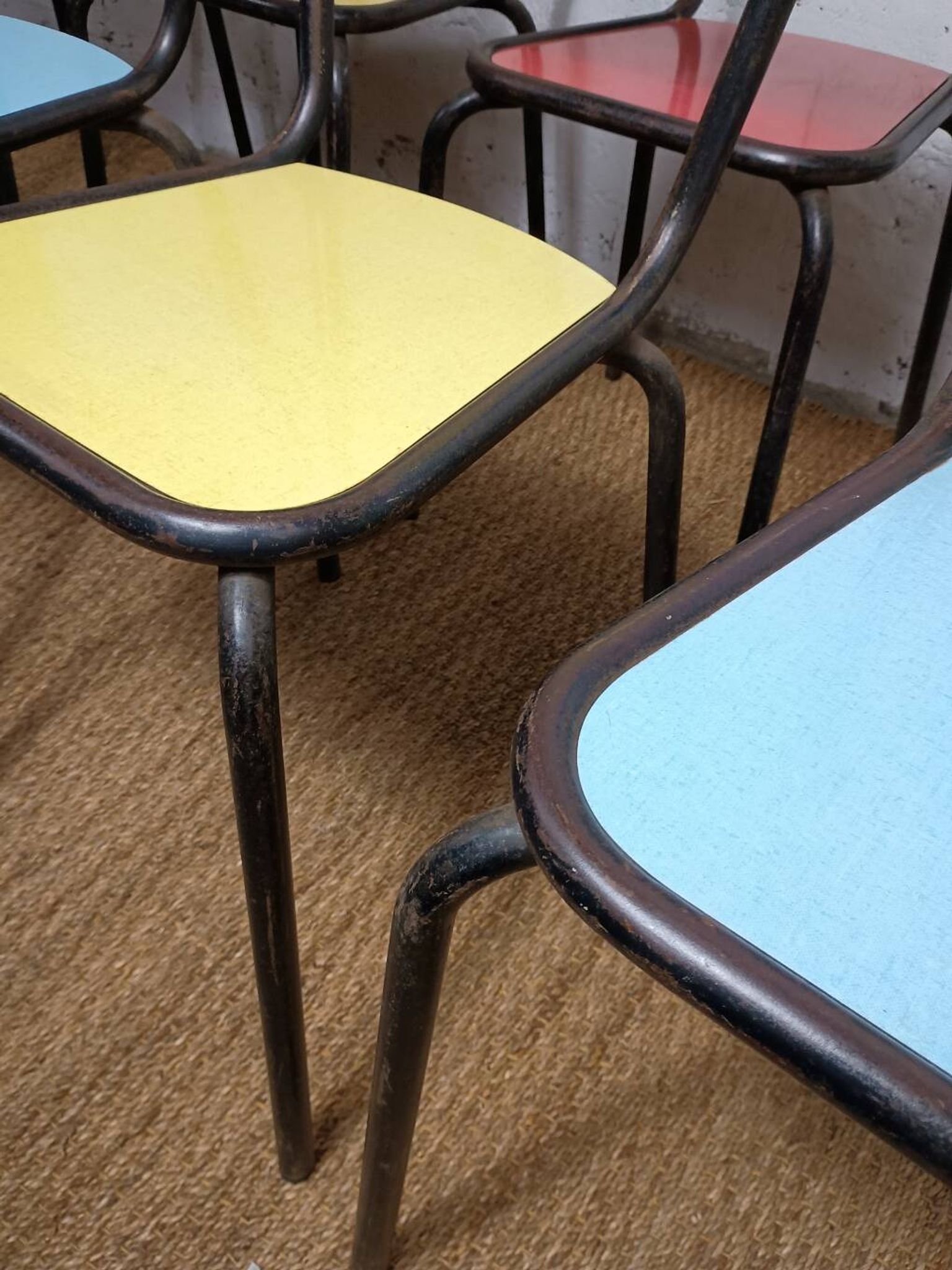 8 canteen chairs, yellow, blue, and red Formica with metal tubing from the 1950s-60s.