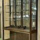 Early 20th-century shop display cabinet in oak with sliding doors.
