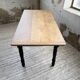 Oak farmhouse table with turned black legs.