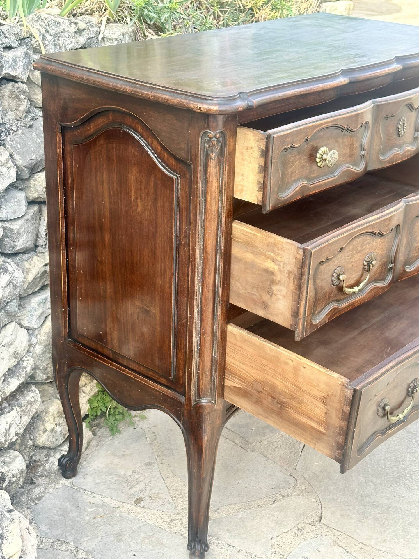 Carved and moulded solid wood commode in the Louis XV style.