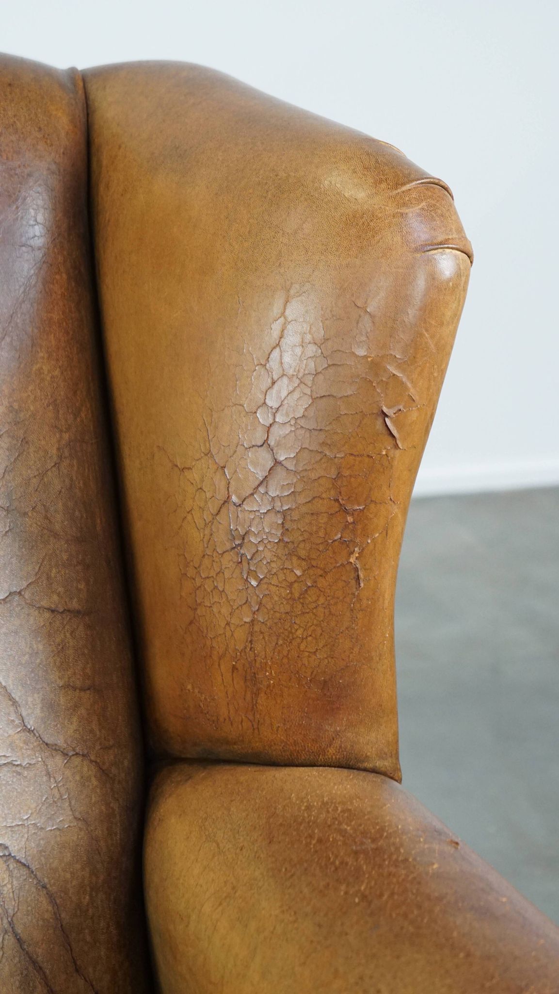 Patinated sheep leather wingback armchair