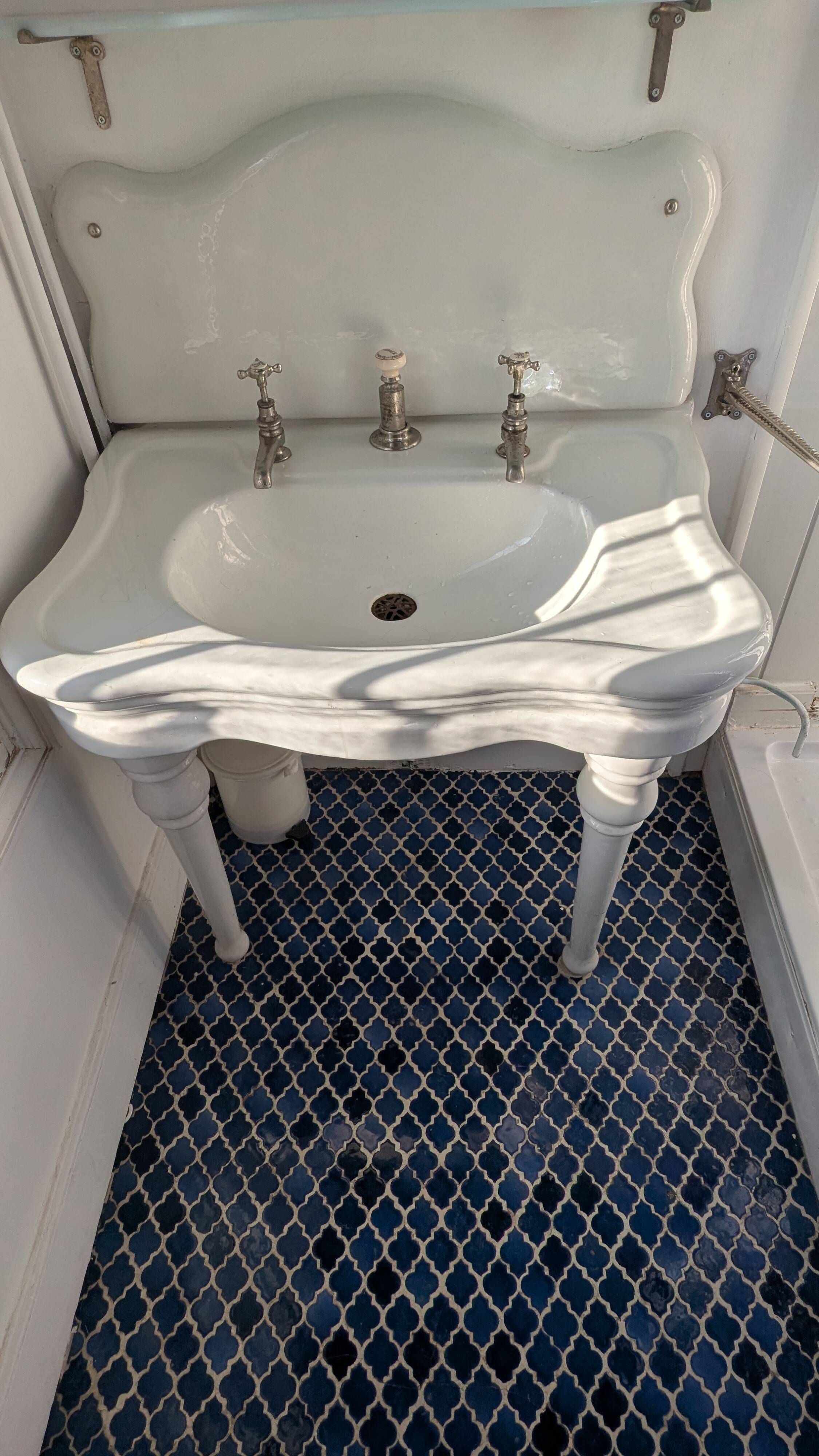 Set of a sink and its retro ceramic splashback.