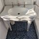 Set of a sink and its retro ceramic splashback.