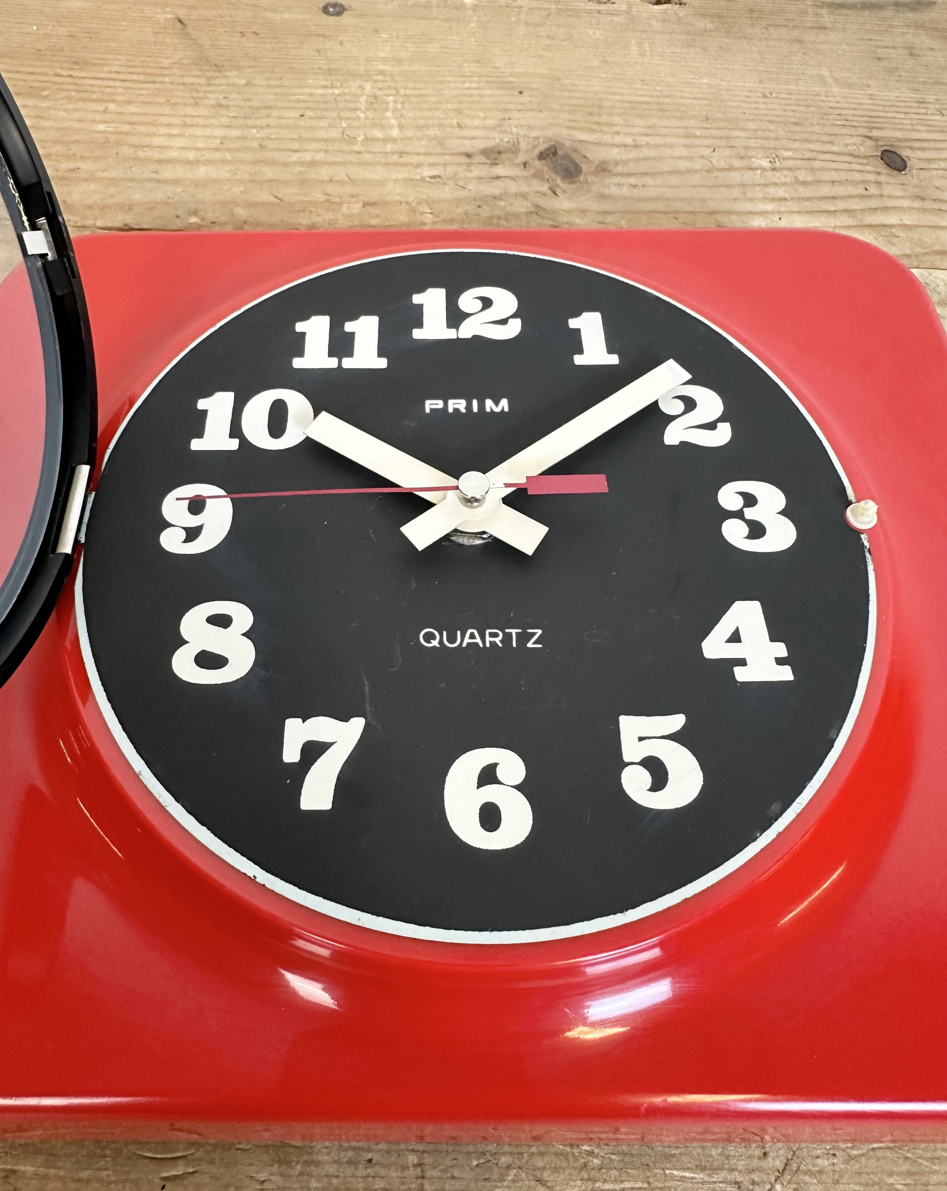 Vintage red bakelite wall clock from prim, 1970s