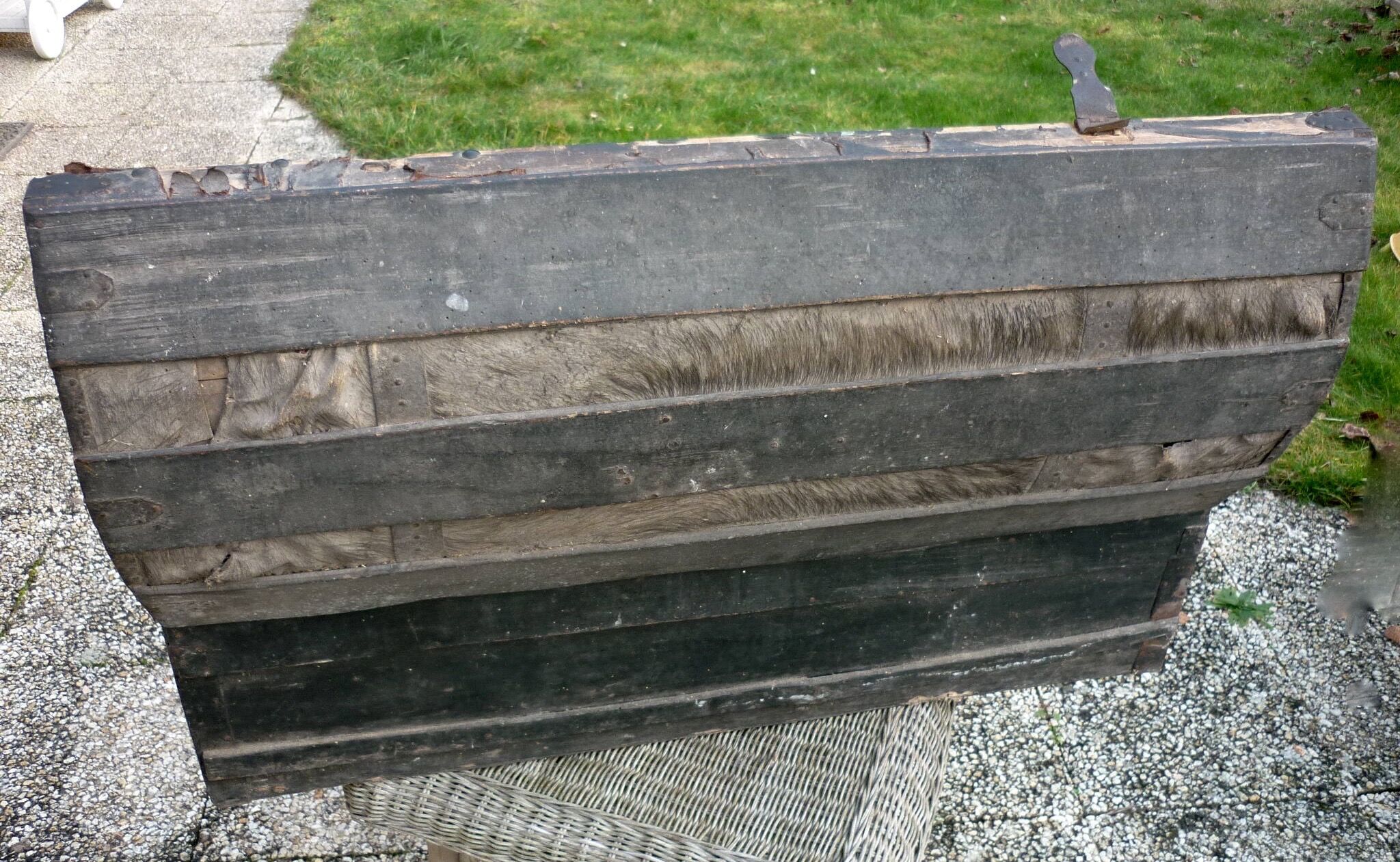 Old bulging wooden travel trunk