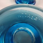 Two small candle holders in blue glass from the well-known Finnish company Ittala.