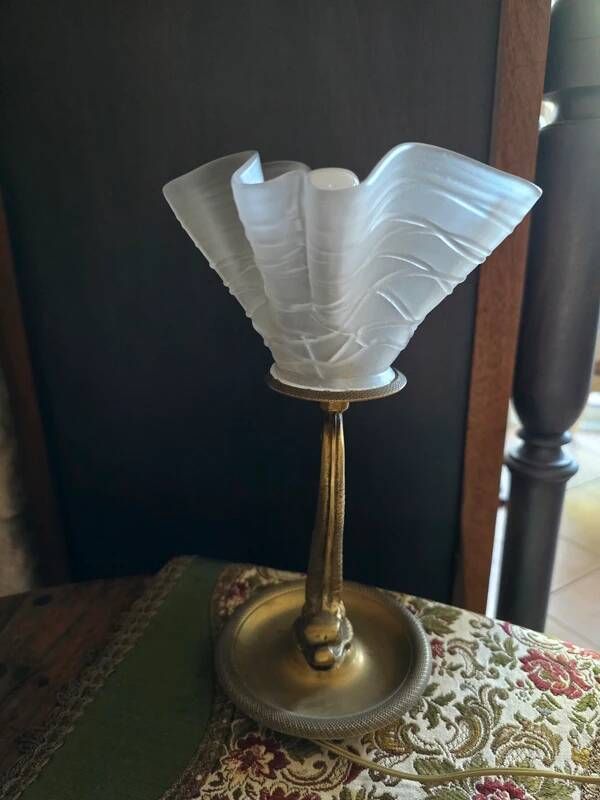 Table lamp with brass fish and draped glass tulip.