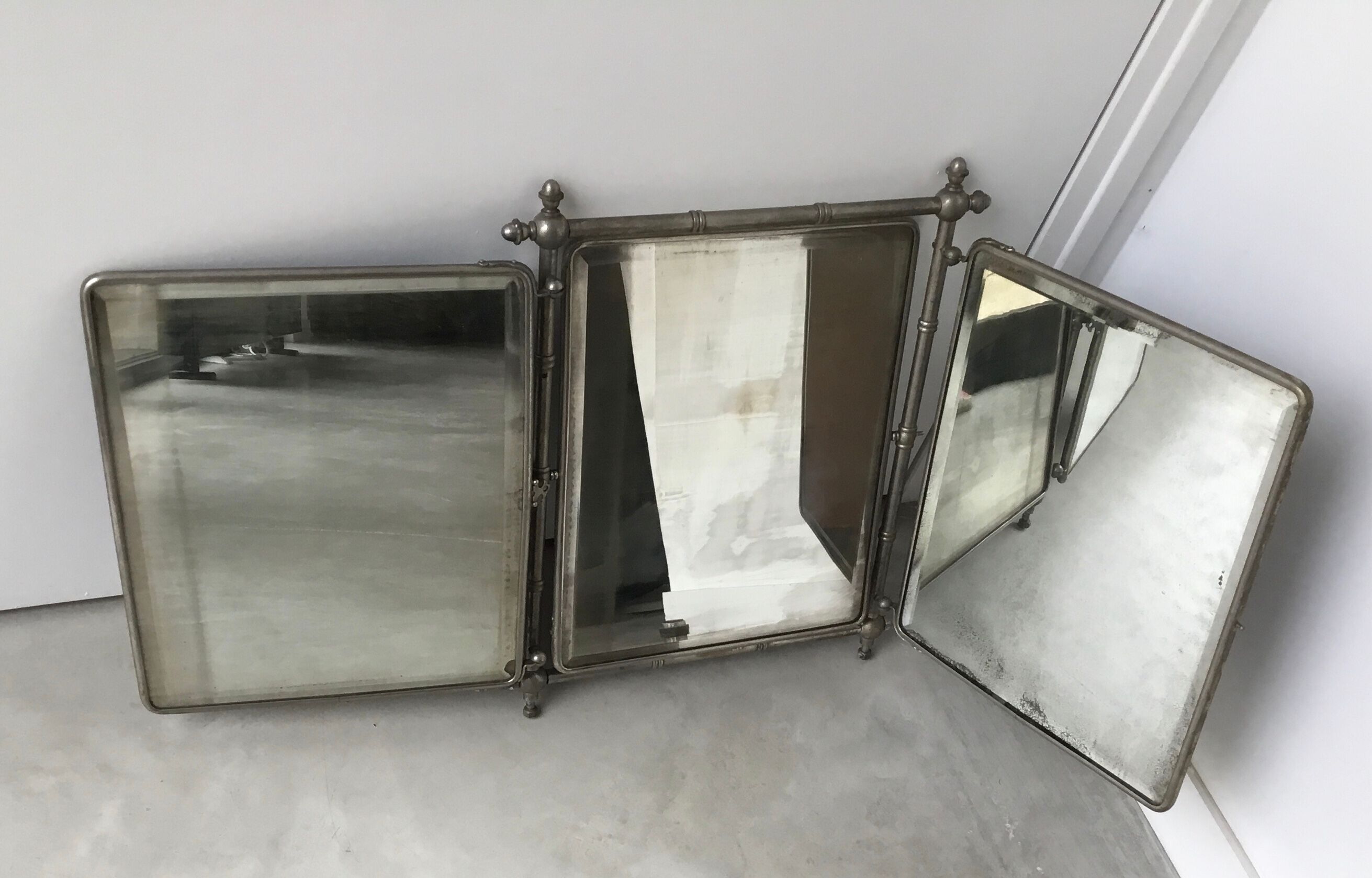 Large and old mirror of tryptic barbier
