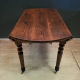 Old round table with folding shutters on casters in solid wood in very good condition