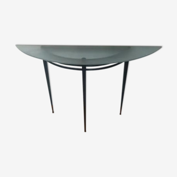 Half-moon console with glass top resting on three tapered legs in black lacquered metal ARTELANO