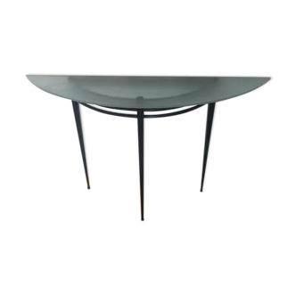 Half-moon console with glass top resting on three tapered legs in black lacquered metal ARTELANO