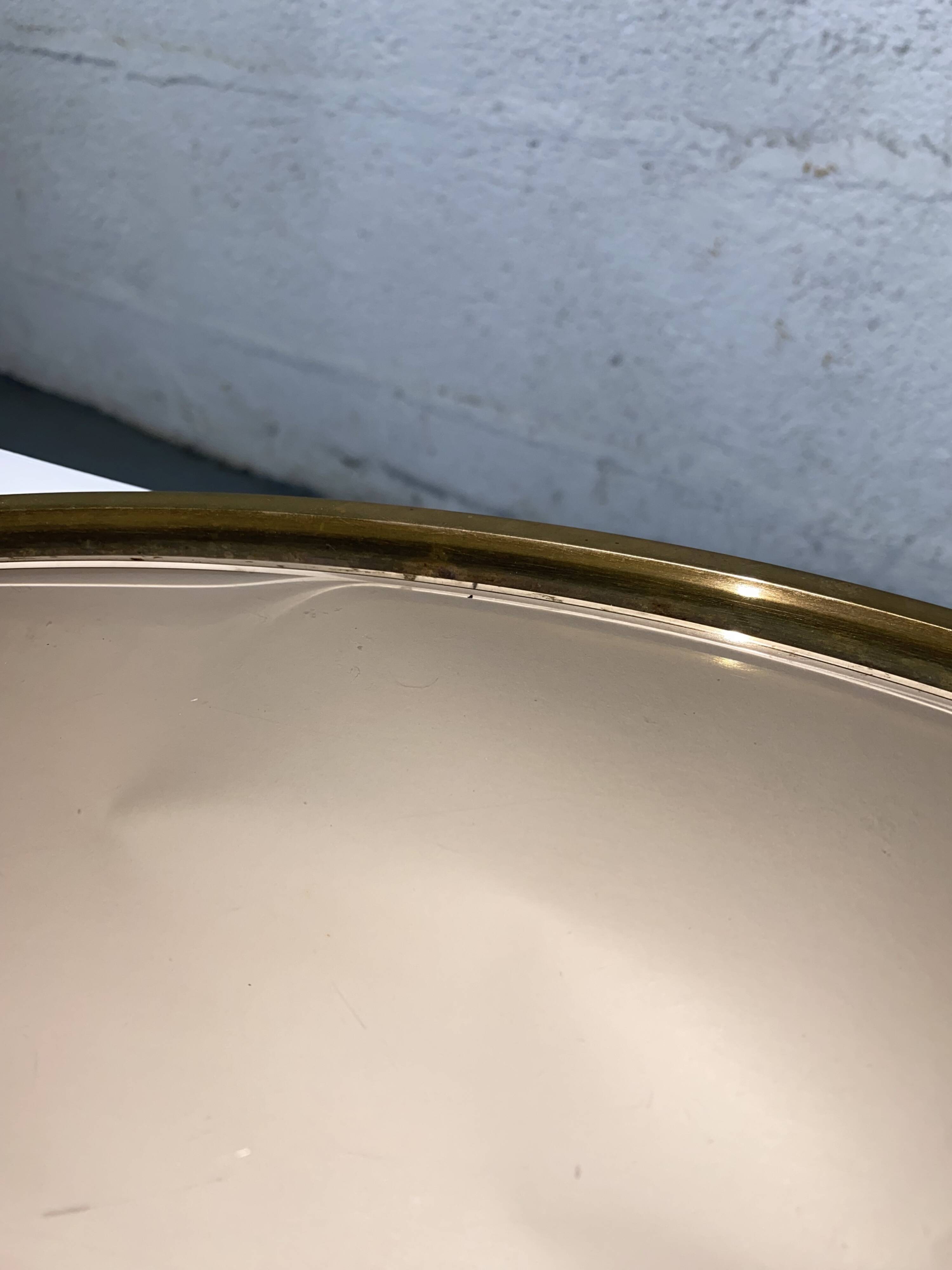 Round coffee table in brass and smoked glass