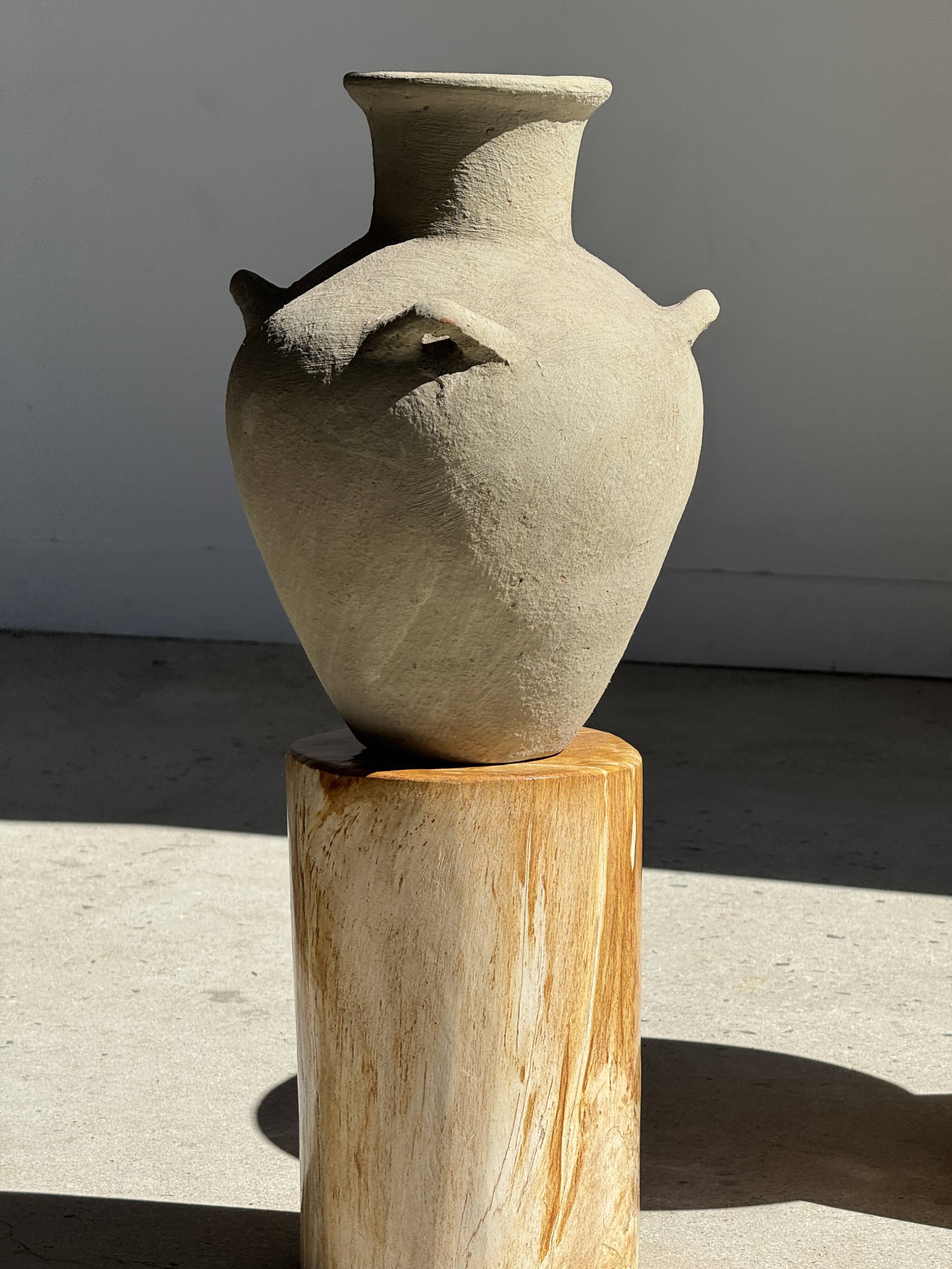 Light beige-grey Indonesian terracotta vase with 4 small handles and a high neck.
