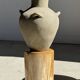 Light beige-grey Indonesian terracotta vase with 4 small handles and a high neck.