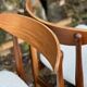 A set of GPlan chairs in teak with a white woolly fabric
