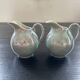 Pair of iridescent blue pitchers